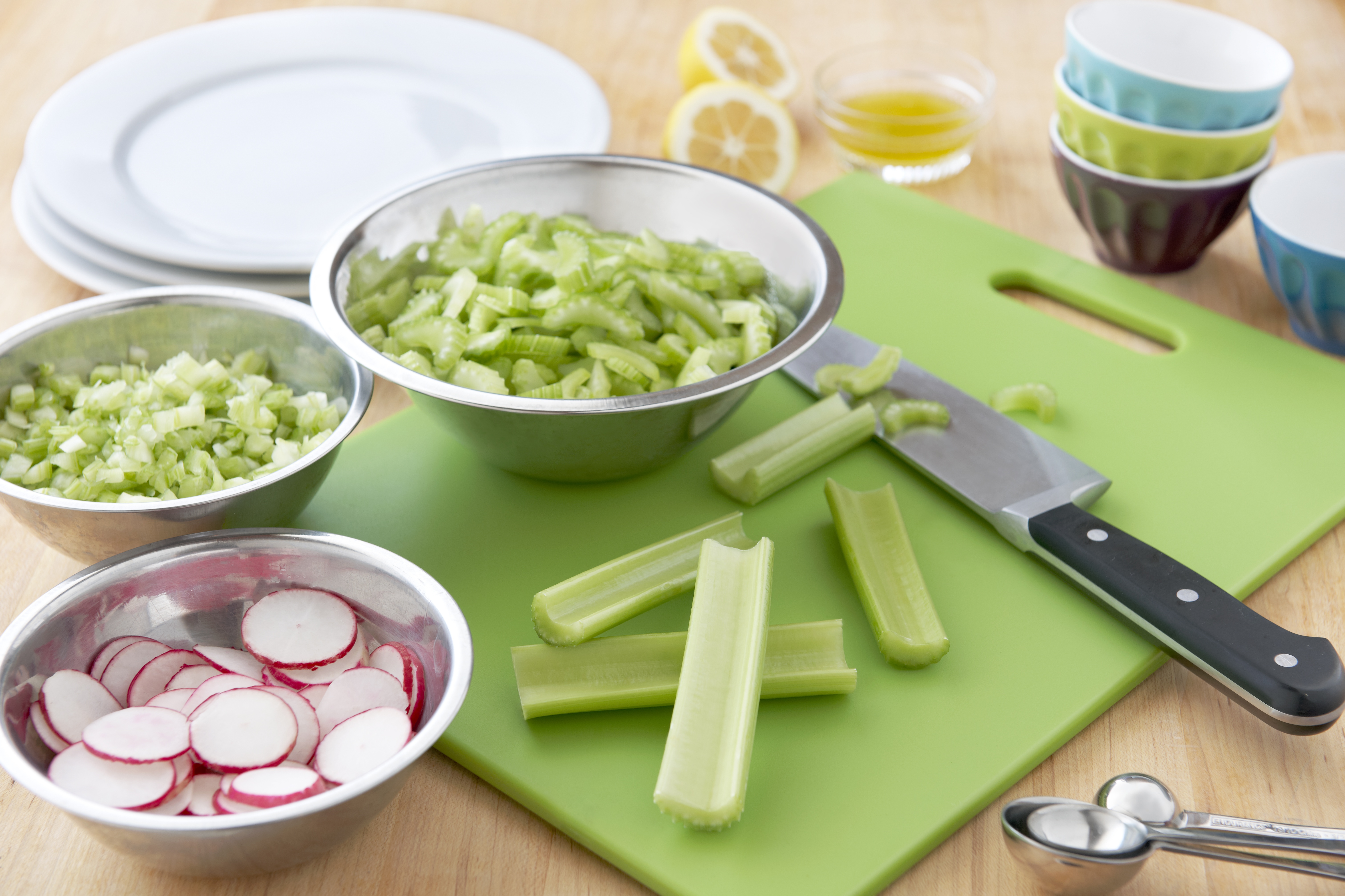 celery and radishes on a cutting board